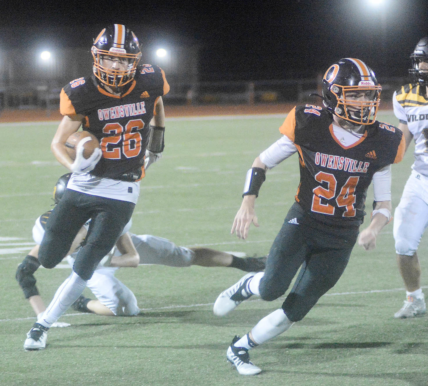 Bryce Payne (left) runs the football with teammate Tanner Meyer out in front of him during Owensville’s 50-0 season-opening victory over Cuba’s Wildcats at Dutchmen Field back in late August. All three gridiron football players were recently named to their All-FRC football teams as voted on by coaches from the Four Rivers Conference (FRC).